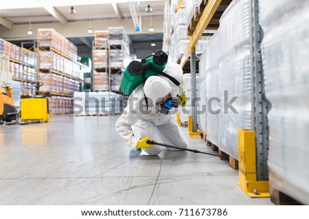 Pest Control Worker Hand Holding Sprayer For Spraying Pesticides in production or manufacturing factory Royalty-Free Stock Photo #711673786