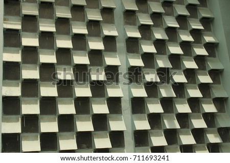 Color decoration of building exterior wall.Concrete ventilating block texture background.The smoothest and most modern blue building in front of architecture and buildings with shade and shade.