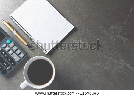 Top view office table with paper and coffee and calculator and pen for business and copy space.