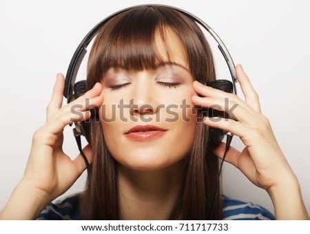 lifestyle and people concept: young woman with headphones listen