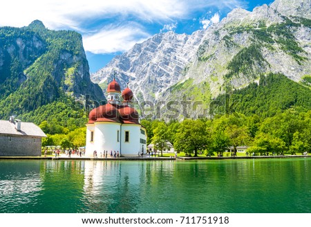 Konigsee lake with st Bartholomew church surrounded by mountains, Berchtesgaden National Park, Bavaria, Germany Royalty-Free Stock Photo #711751918