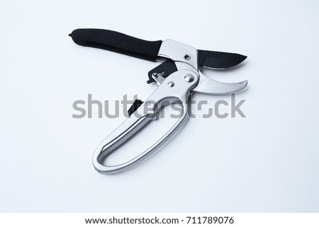 Gardening scissor on white background.