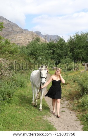 Beautiful blonde with a horse
