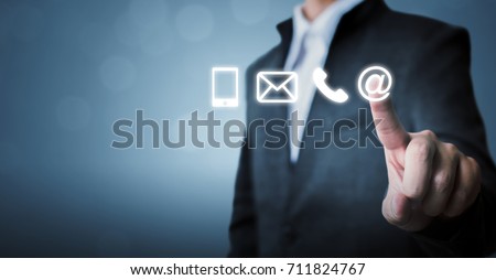Businessman touching icon mobile phone, mail, telephone and address. Customer service call center contact us concept Royalty-Free Stock Photo #711824767