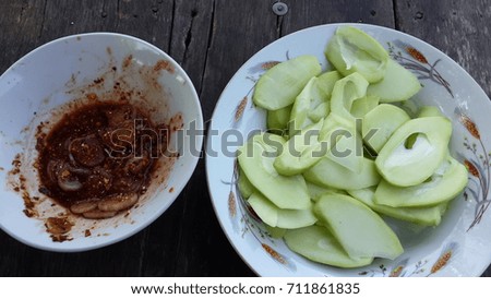 Mangoes with Sweet  sauce on wooden background