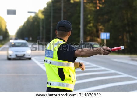 Latvian police man is directing traffic