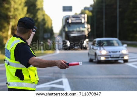 Latvian police man is directing traffic
