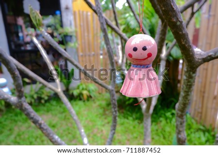Chasing rain Japanese doll hanging under tree on nature backgroud