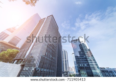 Common modern business skyscrapers, high-rise buildings, architecture raising to the sky, sun. Concepts of financial, economics, future etc.
 Royalty-Free Stock Photo #711905413