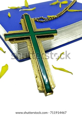 Close up Christian cross and old bible on white background