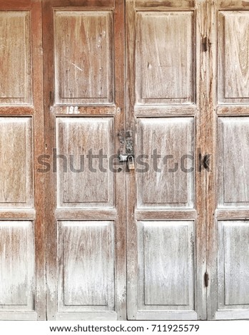 Vintage old wooden door closed by key lock
