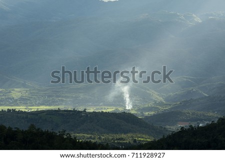 Beautiful sun rays through the clouds over mountains,evening light,Amazing scene