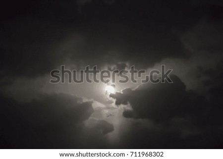 Sun behind dark clouds