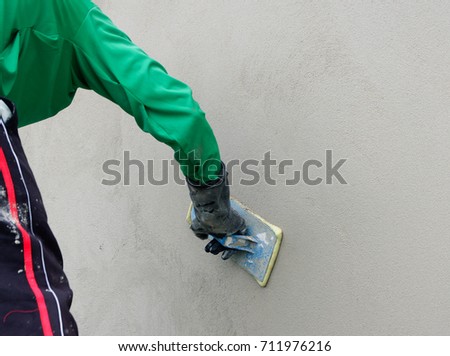 Worker Plastering A Wall