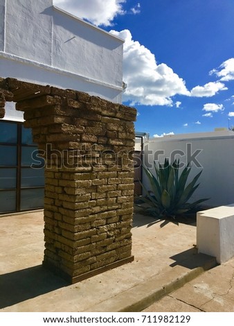 Adobe Brick Art Installation Agave Courtyard Blue Sky Cloud in Marfa
