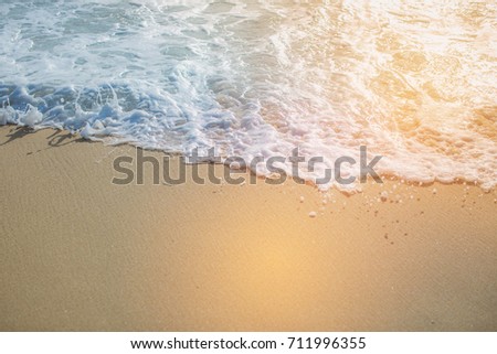 Hipster color close up wave of blue ocean on sandy beach and sunlight background. Chill out concept background.