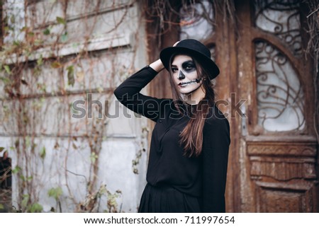 gothic young woman in  halloween costume and halloween make-up Royalty-Free Stock Photo #711997654