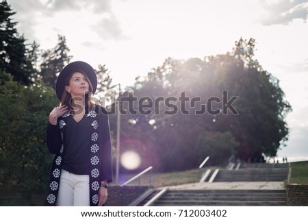 beautiful woman photographed against the spruce tree and and sunbeam