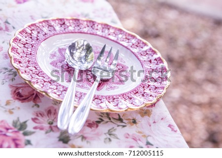 Plate on a pink floral floor.