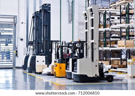 New self propelled lifting platforms in a white warehouse of a factory
 Royalty-Free Stock Photo #712006810