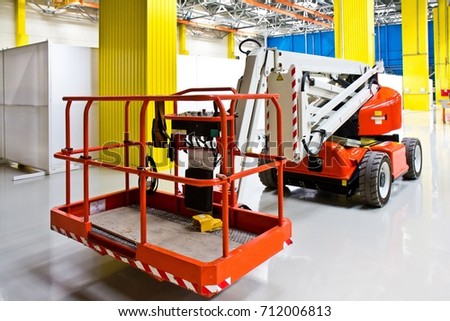 New self propelled lifting platform inside an empty assembly hall
 Royalty-Free Stock Photo #712006813