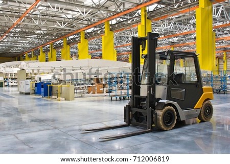 New self propelled lifting platform inside a modern assembly shop full of equipment
 Royalty-Free Stock Photo #712006819