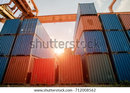 sunshine on the stack of cargo container and crane in port Royalty-Free Stock Photo #712008562