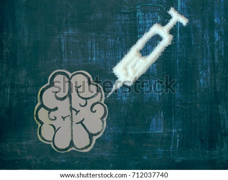 the concept of sugar addiction  / the painted brain and a syringe of sugar Royalty-Free Stock Photo #712037740