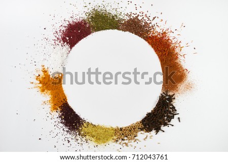 Circle frame composition of spices and herbs isolated on white background with copy space. Frame of Indian spices and herbs. Ingredients of asian cuisine spices Royalty-Free Stock Photo #712043761