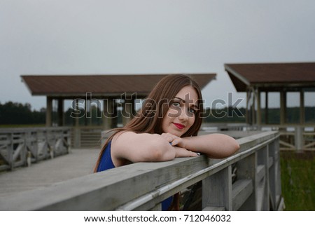 The girl with long hair on the pier