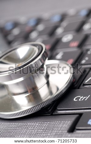 stethoscope on the laptop keyboard close up
