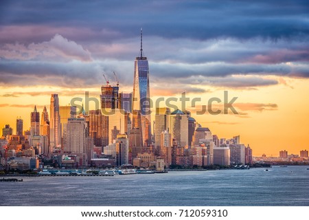 New York City financial district on the Hudson River at dawn.