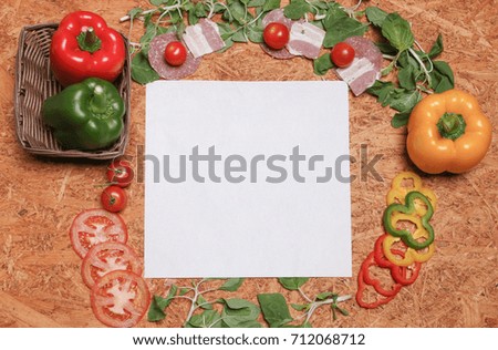 Food ingredients of pizza and spices for cooking bell pepper, tomatoes, ham, spinach, and delicious italian pizza and blank white paper. Copy space. Top view. Banner