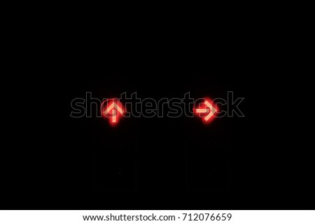 Red traffic light with straight and turn right sign with silhouette bird