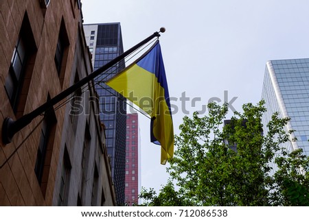 Ukrainian flag on the building Flag of Ukraine with a black mourning ribbon.