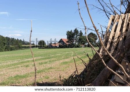 for a midsummer festival bonfire on a very sunny day in august in south germany you see woodpile beside a tent right before burning for a huge fire