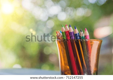 Color pencils in glass on bokeh background