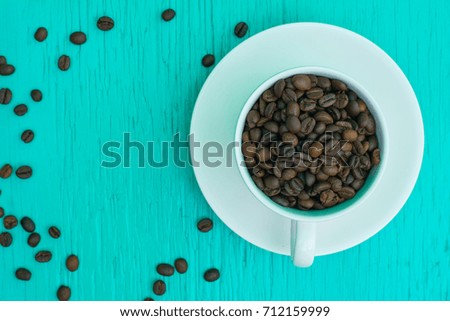 Coffee espresso and coffee cup and beans on table,Tea cup on table,warm cup of coffee on brown background,