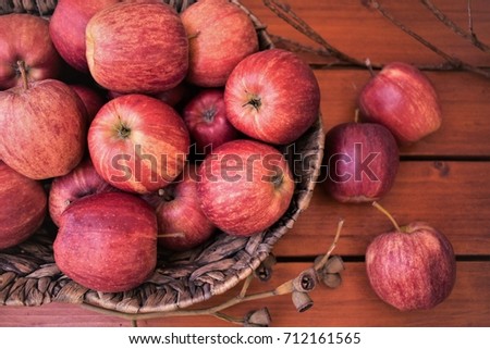 Red apples in the wicker basket, autumn harvest.