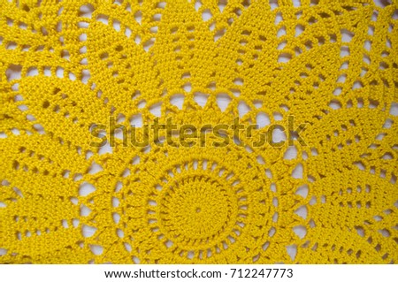 Yellow crocheted handmade handkerchief in the form of sunflower.
