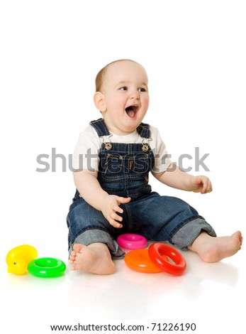 boy playing with colorful pyramid toy isolated on white