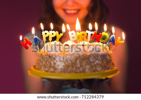 Hands of young woman holding birthday cake selective focus Royalty-Free Stock Photo #712284379