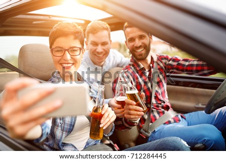 summer vacation, holidays, travel, road trip and people concept- happy friends taking selfie
