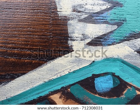 Painted colorful tribal pattern on wood texture for interesting backgrounds.