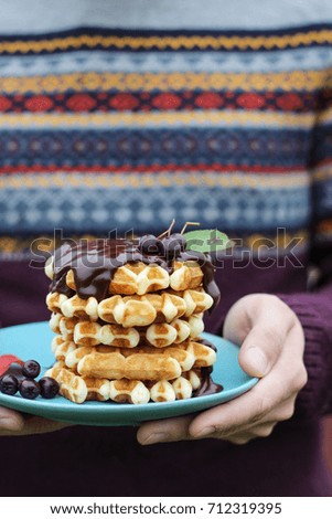 Wafers with chocolate in hands