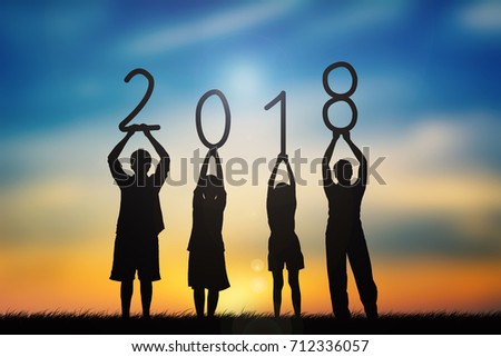 Silhouette of family holding 2018 word at sky sunset background, concept happy new year  Royalty-Free Stock Photo #712336057