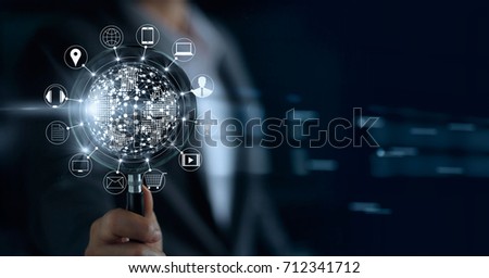 Businessman holding magnifying glass, search payments online shopping and icon customer network connection on screen, m-banking and omni channel  Royalty-Free Stock Photo #712341712