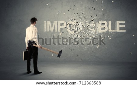 Business man hitting impossible sign with hammer on grungy wall