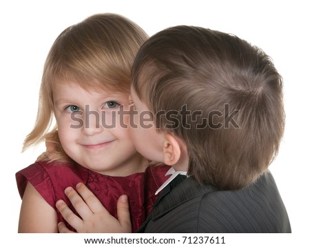 A little boy is kissing a pretty blonde girl; isolated on the white background