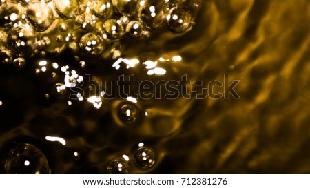 Gold Bokeh air bubbles in water on golden background